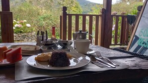 A table set with a plate of food, a teapot, cups, and cutlery. - Best immersion experience in a Farm at Finca Queveri (Orosi)