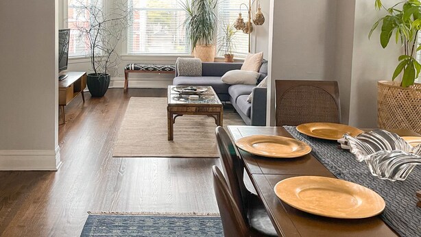 A spacious living room with a dining area, large windows, and a chandelier. - Family-friendly, stylish Chicago Apartment in Logan Square (Chicago)