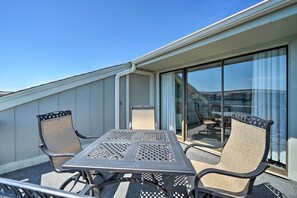 Enjoy a peaceful moment on the balcony with a table and two chairs.