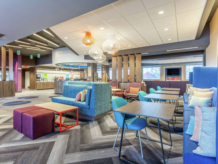 A modern lounge area with seating, a coffee table, and a TV screen.
