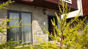 Stunning building with a stone facade, wooden accents, and lush green surroundings.