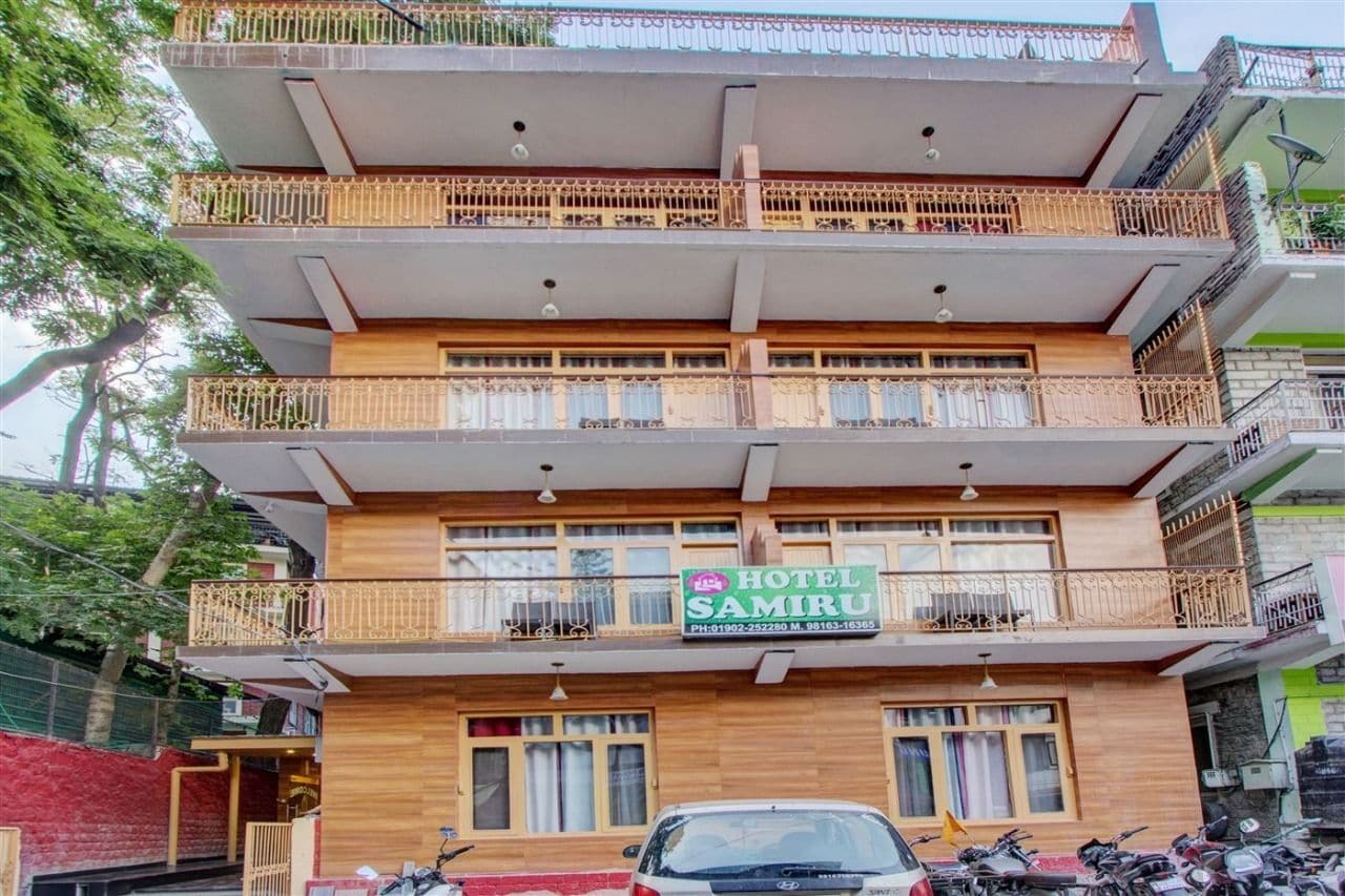 A multi-story building with a sign for "Hotel Samiru" on the ground floor.