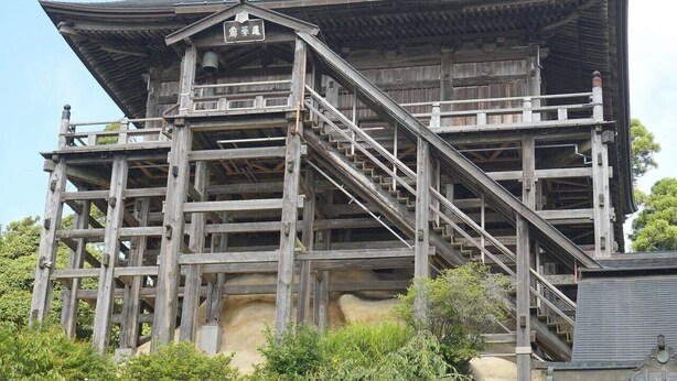 A traditional wooden building with a steep staircase leading to a balcony. - Hotel Swan Lake Nagara (Ichihara)