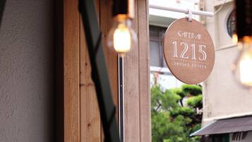 A cafe sign with the number 1215, indicating its address.