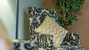 A chair with a black and white patterned upholstery and a yellow chevron pillow. - Minutes to Airport, Waterfront and Downtown Sleeps 6 (Bellingham)