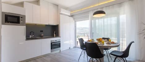 Apartment, Sea View | Living area | Flat-screen TV