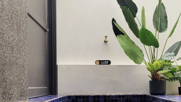A small, enclosed pool area with blue-tiled flooring and potted plants. - Top Sunlight Inn (Liuqiu)