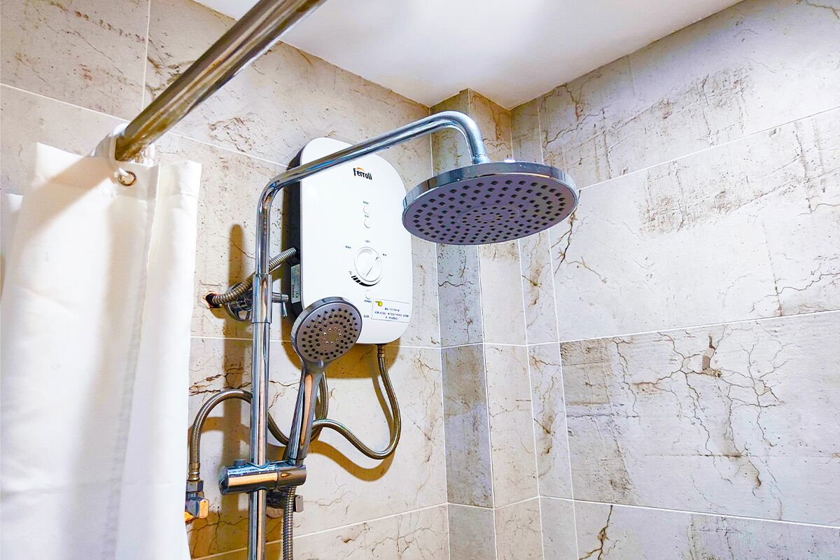 Una ducha moderna con panel de control, cabezal de ducha de mano y cabezal de ducha fijo.