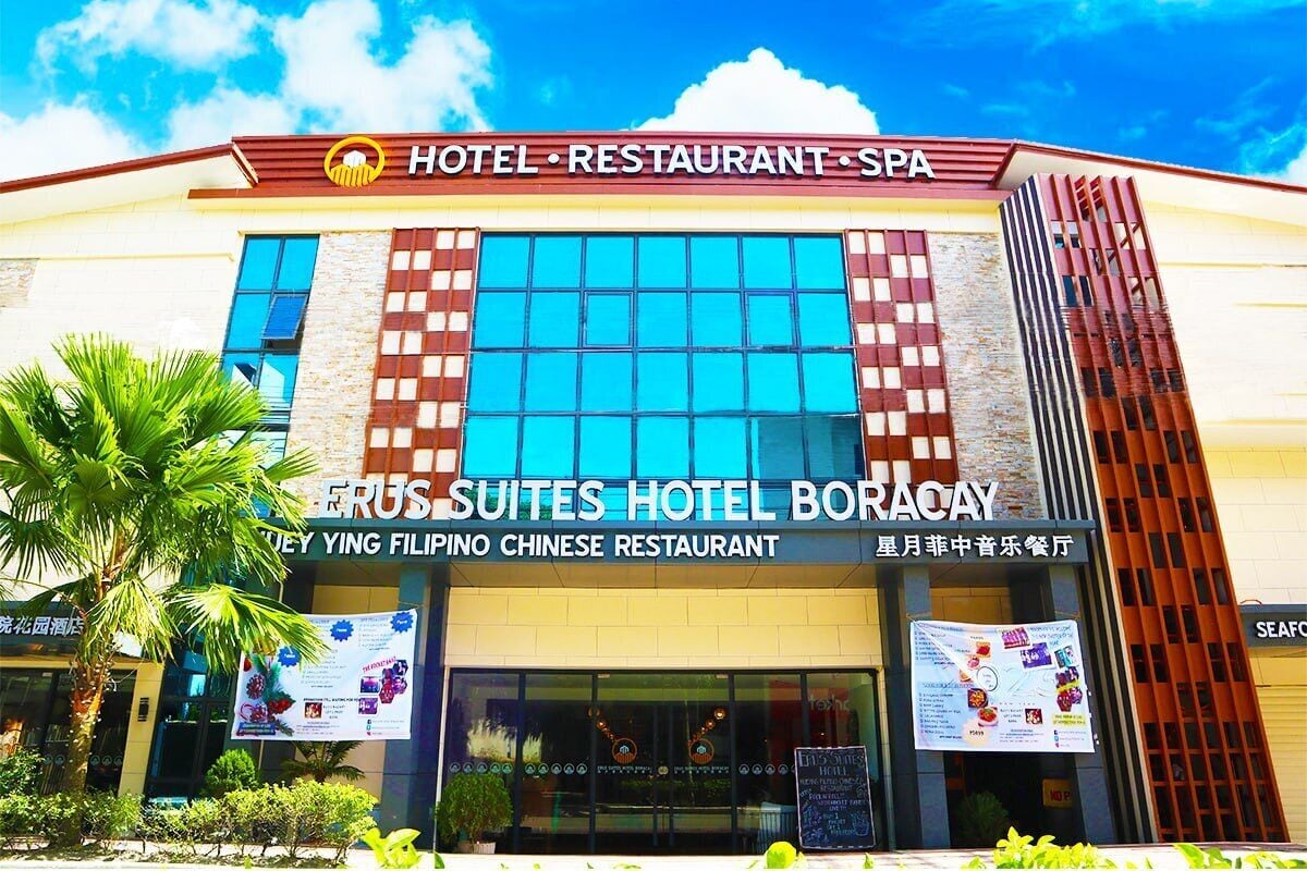 A hotel with a sign for 'ERUS Suites Hotel Boracay' and a 'Ying Filipino Chinese Restaurant'.
