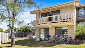 A two-story building with a balcony, a covered porch, and a row of bicycles parked outside. - Galleries - 1/28 Peregian Esplanade - Peregian Beach (Peregian Beach)