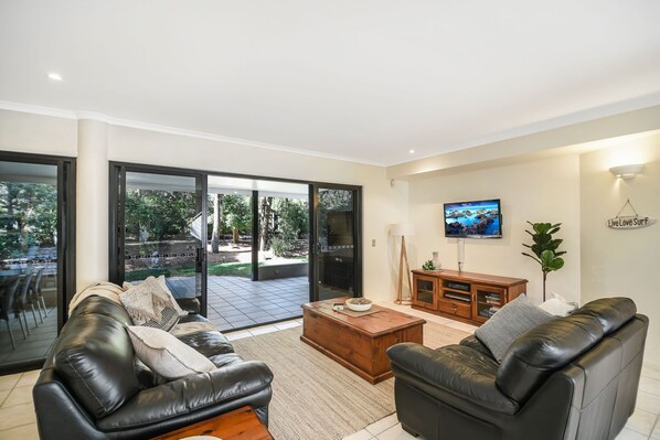 A modern living room with a sofa, coffee table, and TV.