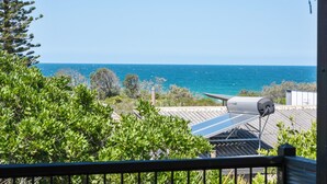 A balcony with a view of the ocean, solar panels, and a satellite dish. - 40 Jacana Street, Peregian Beach (Peregian Beach)