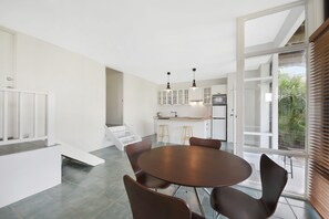 A modern kitchen with white cabinets, a central island, and pendant lighting. - 69 Mahogany Drive, Marcus Beach, Noosa Area (Marcus Beach)
