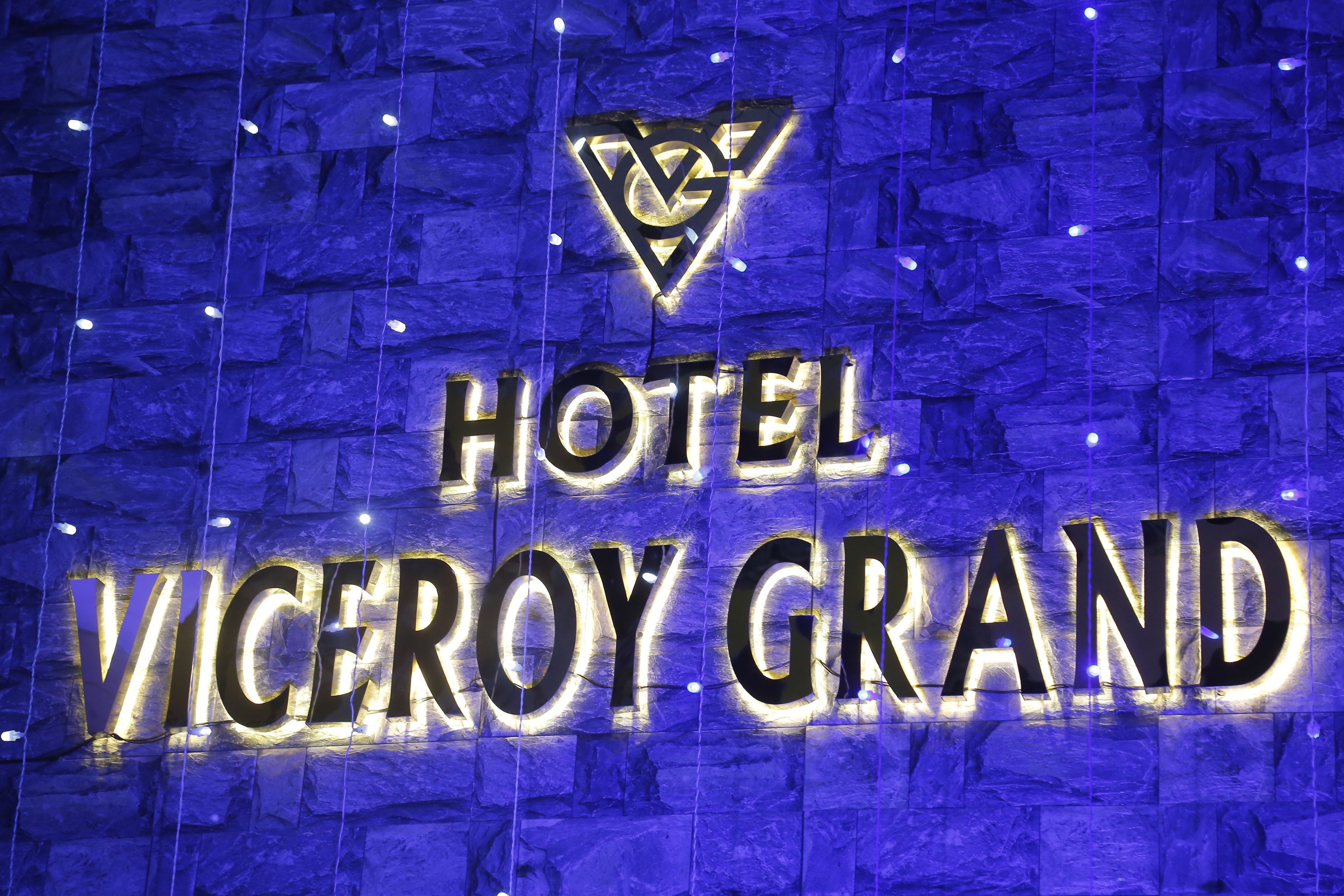 A sign for 'Hotel Viceroy Grand' with a logo above the text.