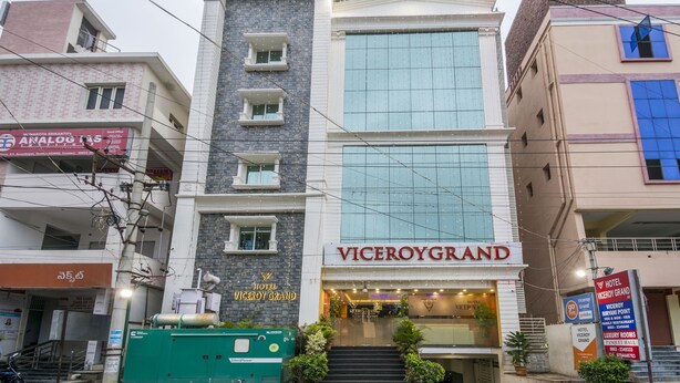 A hotel with a modern facade, multiple windows, and a prominent entrance. - Ostin Viceroy Grand (Guntur)