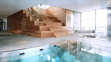 Relax by the glass-bottomed pool with steps leading down for a serene spa experience.