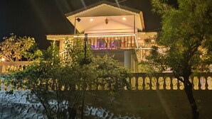A two-story building with a balcony and a covered entrance. - Ekdant Holiday Home (Murud)