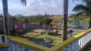 A playground with swings, a slide, and a trampoline. - Chácara Recanto do baiano (Sorocaba)