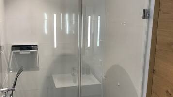 Shower, rainfall showerhead, hair dryer, towels