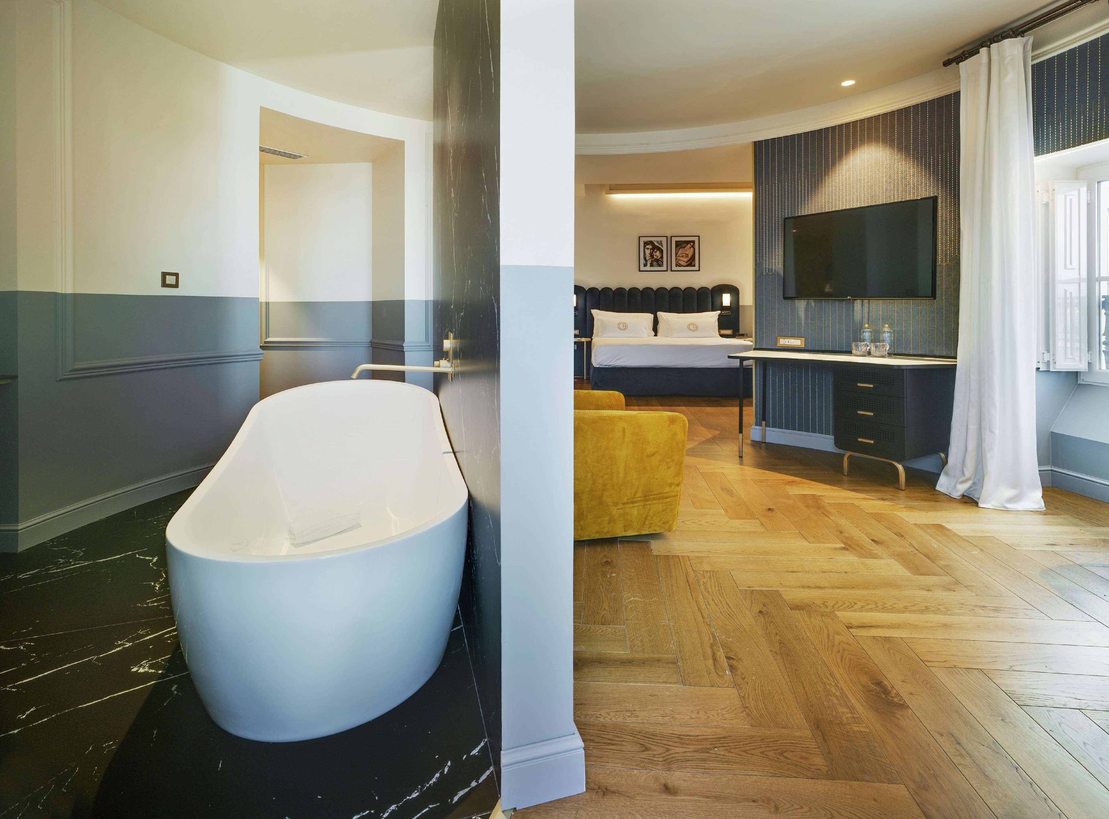 Un baño moderno con una bañera independiente, zona de ducha y tocador con espejo.