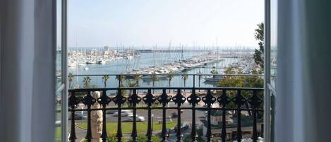 A balcony with a view of a marina and boats.