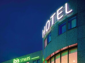 Hotel ibis styles features a modern exterior with a textured facade and large windows.