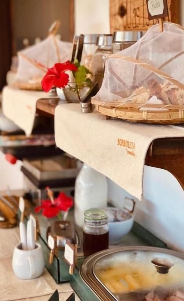 A buffet setup with various food items and condiments.
