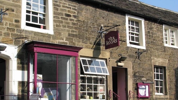 A stone building with a sign reading "Tea Rooms" and a window display with various items. - sweet heART Tea Rooms Accommodation (Harrogate)