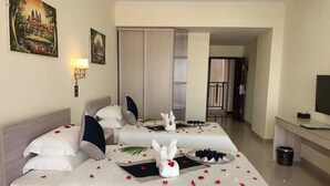 A hotel room with two beds, a desk, and a television. - City Comfort Airport Hotel Phnom Penh (Phnom Penh)
