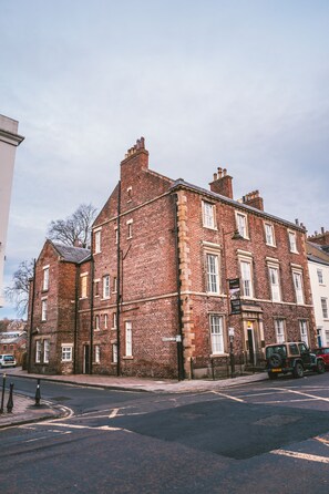 A multi-story brick building with a traditional design, featuring multiple windows and a visible entrance. - 52 Old Elvet (Durham)