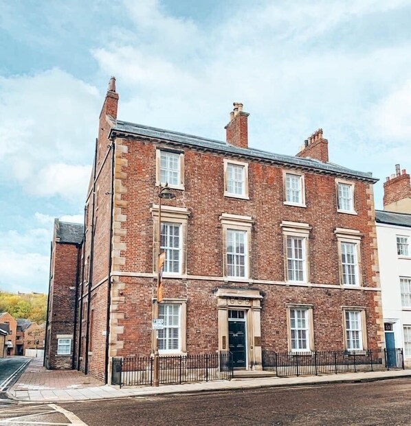 A two-story brick building with a symmetrical facade, multiple windows, and a central entrance. - 52 Old Elvet (Durham)