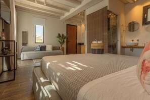 A bedroom with a large bed, a smaller bed, a desk, and a potted plant. - Nami by Maregold Mykonos, Adults Only (Mykonos)