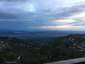 A panoramic view of a mountainous landscape with scattered buildings.
