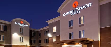 A multi-story hotel with a prominent 'CANDLEWOOD SUITES' sign.
