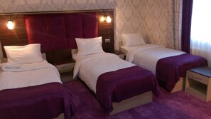 Standard Triple Room | In-room safe, individually decorated, desk, laptop workspace