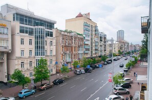 A multi-story building with a mix of architectural styles, including a prominent curved facade and a flat-roofed structure with balconies.