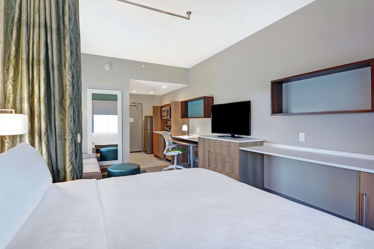 Premium bedding, desk, laptop workspace, blackout drapes
