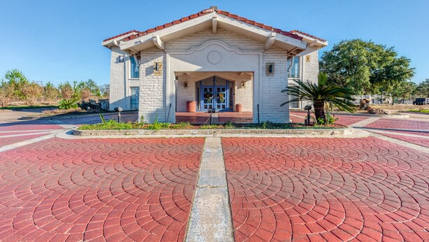 A small building with a red-tiled roof and a central entrance. - Baymont by Wyndham Nacogdoches Near University (Nacogdoches)