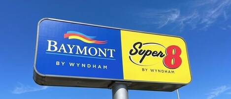 A sign with 'Baymont by Wyndham' and 'Super 8 by Wyndham' logos.