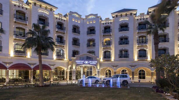A multi-story hotel with a grand entrance, multiple balconies, and a well-lit facade. - Crowne Plaza Riyadh Al Waha by IHG (Riyadh)