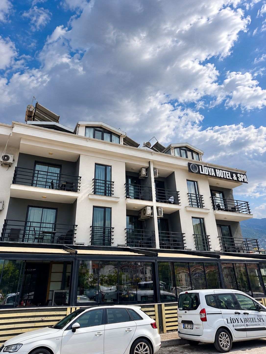 A hotel building with multiple balconies and a sign reading 'Lidya Hotel & SPA'.