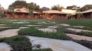 A rural landscape with terraced fields and traditional houses with tiled roofs. - Pousada das Papoulas (Búzios)