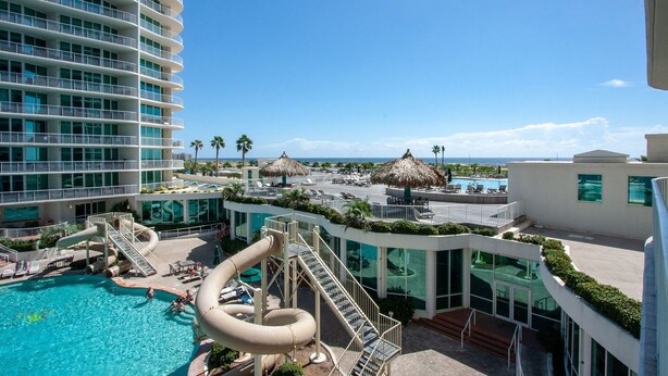 A resort with a large pool, water slides, and a view of the ocean. - Poolside Condo With Bay Views - Unit Crc0309 (Orange Beach)