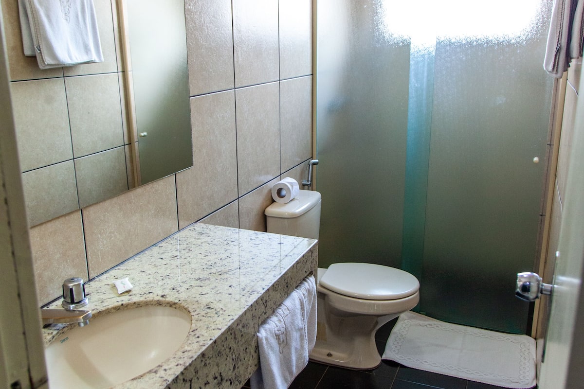 luxury single room | bathroom | shower, towels, soap, toilet paper