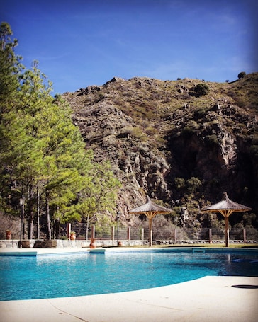 Seasonal outdoor pool, open 10:00 AM to 8:00 PM, pool umbrellas. Paso del Cóndor