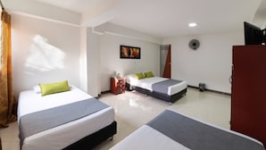 A hotel room with two beds, a dresser, a TV, and a painting on the wall. - Ayenda 1234 Imperio 70 (Medellín)