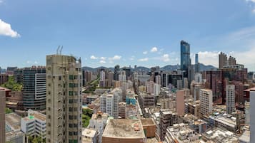 A cityscape with high-rise buildings, including a prominent curved structure and a tall skyscraper with a glass facade.