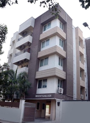 A multi-story residential building named Mount Kailash with balconies and air conditioning units.