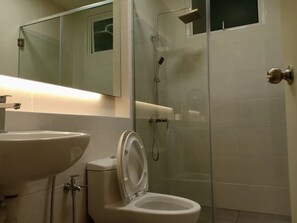 A bathroom with a sink, toilet, and glass-enclosed shower. - BLeisure Parkland Homestay (Malacca City)