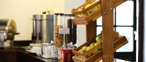 A breakfast buffet with various food items and a coffee station.